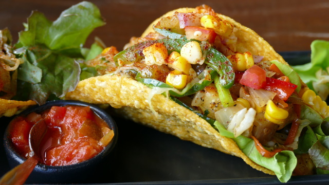 Fish taco with veggies in a corn tortilla